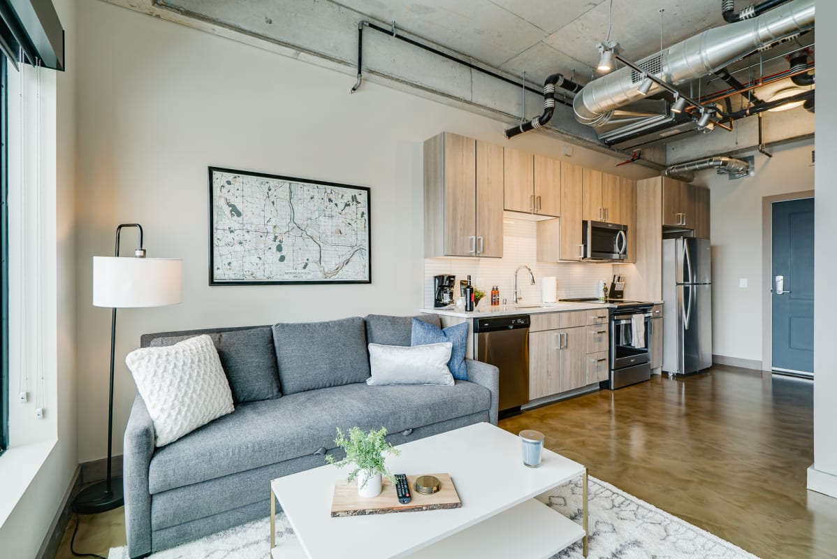 Unwind in your modern loft with sleek kitchen, cozy seating, and industrial chic details that make city living feel like home.