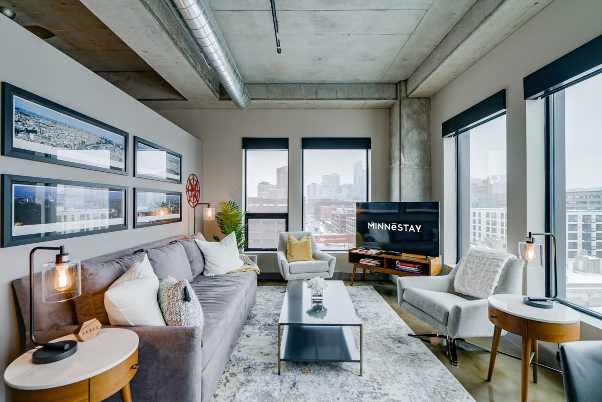 Settle into your modern loft with soaring ceilings and stunning city views through floor-to-ceiling windows.