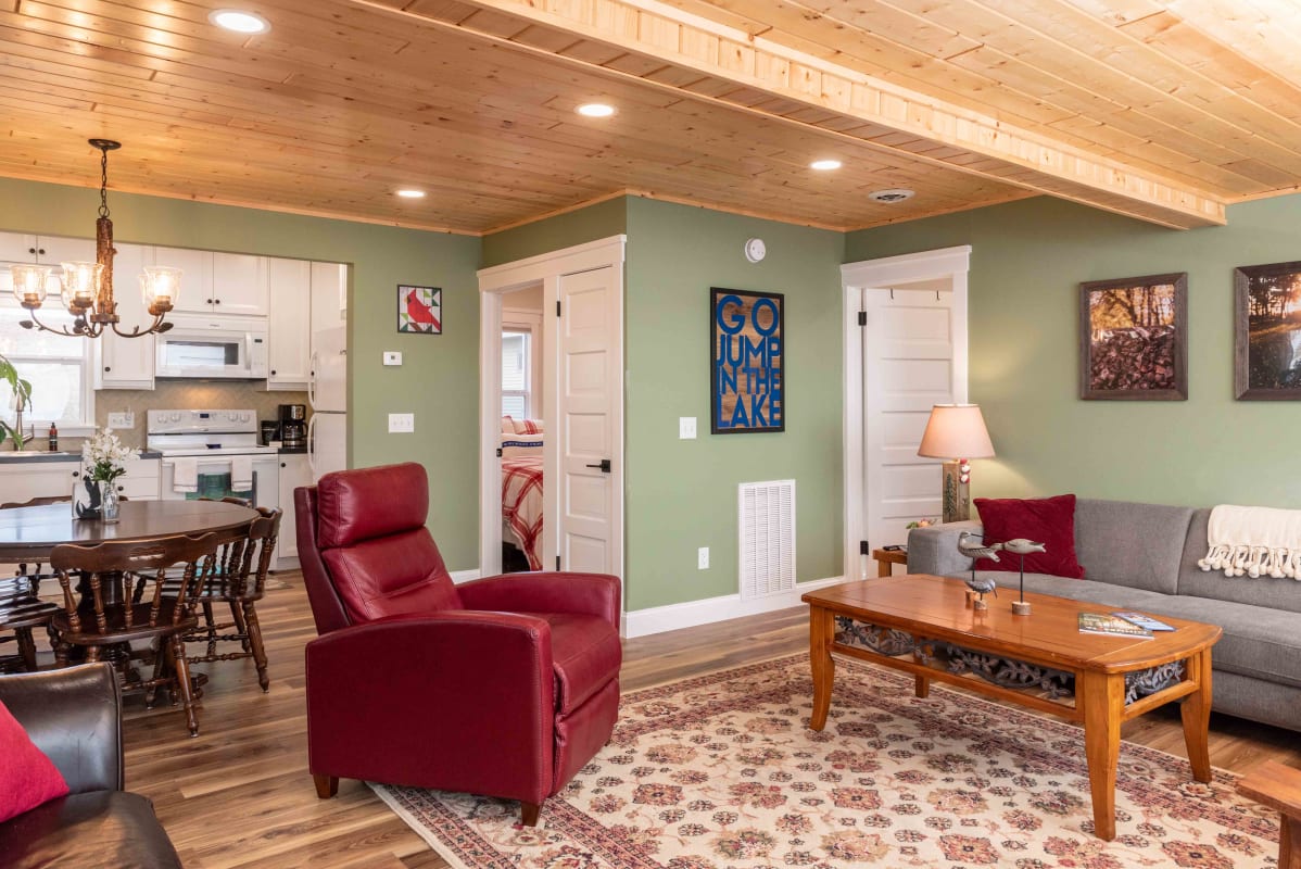 Relax in your cozy living space with warm wood beams overhead and comfortable seating perfect for unwinding after lake adventures.