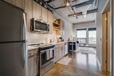 Contemporary apartment kitchen with stainless steel appliances and sleek design.