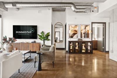 Modern living room with contemporary furniture and decor elements, featuring a TV display.