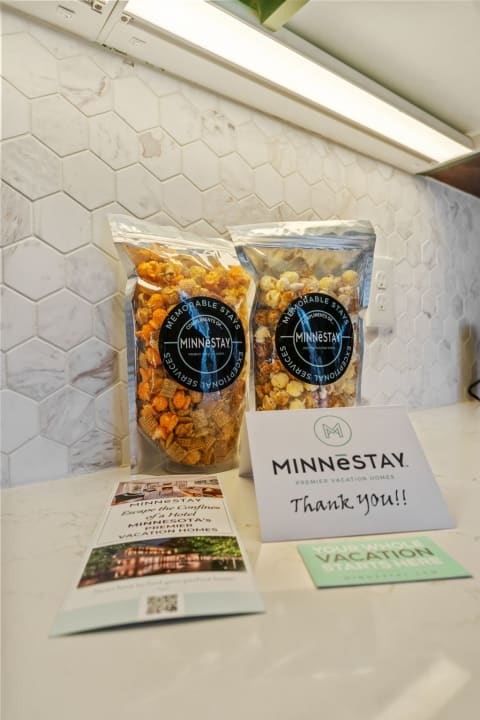 Popcorn bags and promotional materials from MINNESTAY on a marble countertop.