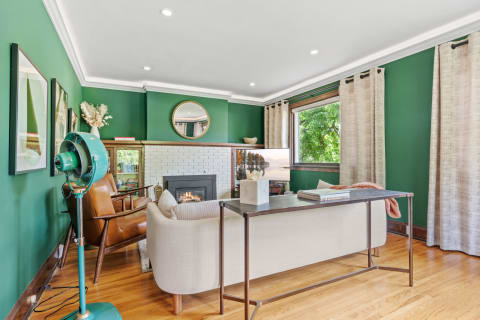 Cozy living room with a green color scheme and modern decor.