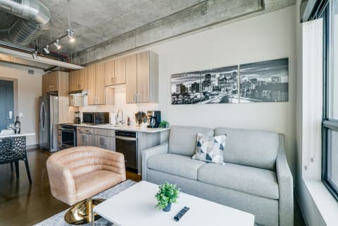 Contemporary apartment interior featuring a kitchen and living room arrangement.