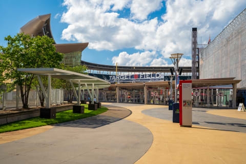 A view of the entrance to Target Field with a winding walkway and modern architecture.