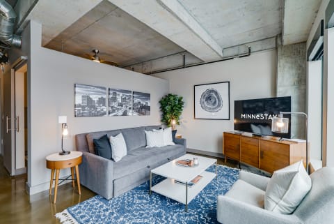 Stylish modern living room with gray sofa and decorative items.