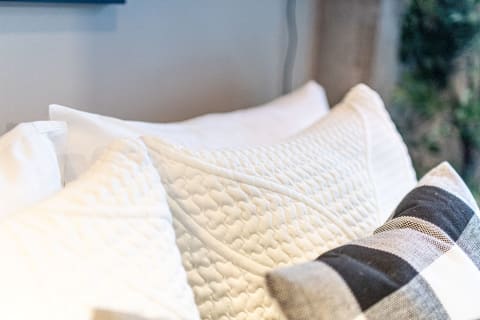 A close-up view of three decorative pillows in a cozy setting.