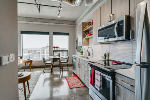 Modern kitchen with stainless steel appliances and a view of the city.