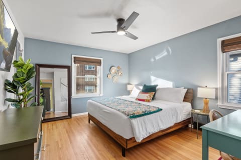 Cozy and stylish bedroom with a queen-sized bed and artistic wall decor.