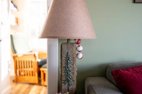 A rustic lamp with a wooden base and a fabric shade in a cozy room.