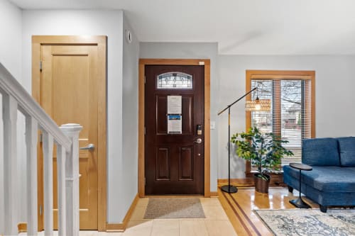 Step into your welcoming entryway where warm wood tones and natural light create an inviting atmosphere for your stay.