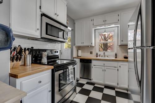 Your fully equipped kitchen features warm wood countertops, modern appliances, and cheerful window views for memorable meal prep.