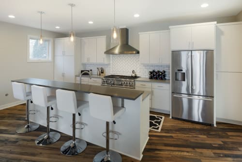 Your sleek modern kitchen awaits with gleaming stainless steel appliances, spacious island seating for four, and everything you need to create memorable meals.