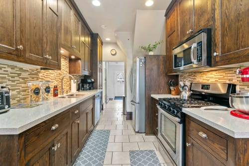 Your fully equipped kitchen features rich wood cabinetry, granite countertops, and stainless steel appliances—perfect for preparing memorable meals during your stay.