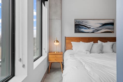 Sink into plush white bedding and let the natural light brighten your mornings in this serene bedroom retreat.