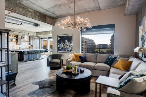 Unwind in your stylish loft with soaring concrete ceilings, plush sectional seating, and stunning city views.