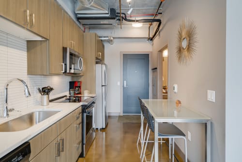 Your sleek modern kitchen features stainless steel appliances and a convenient breakfast bar for casual dining.