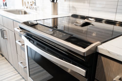 Your modern kitchen features a sleek glass-top stove with built-in oven, perfect for preparing memorable meals during your stay.