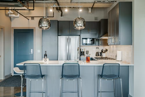 Savor morning coffee at your sleek kitchen island, with modern appliances and designer pendant lighting creating the perfect culinary experience.