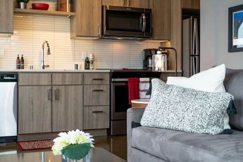 Unwind in your stylish open-concept space where the fully-equipped kitchen meets cozy living area, perfect for cooking and relaxing together.