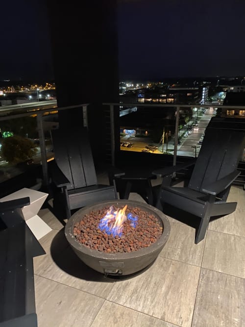Gather around the glowing fire pit on your private balcony, where city lights create a magical backdrop for evening conversations.