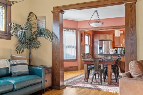 Relax in your stylish living room with rich wood details, then gather around the dining table for memorable meals together.