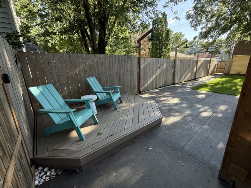 Relax in your private backyard deck with comfy Adirondack chairs, perfect for morning coffee or evening conversations.