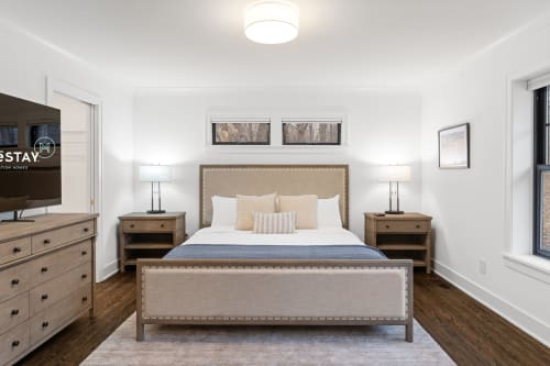 Unwind in your serene bedroom sanctuary with plush bedding, warm wood furnishings, and thoughtful touches that create the perfect space for restful nights.